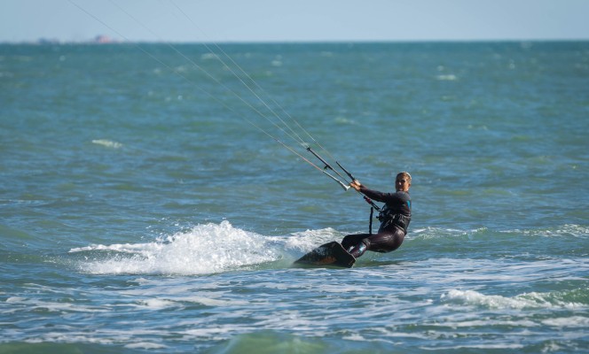 Marina di San Nicola, Italy - October 08, 2020, Lone kiter in sunny weather on the beach of Marina di San Nicola in Italy